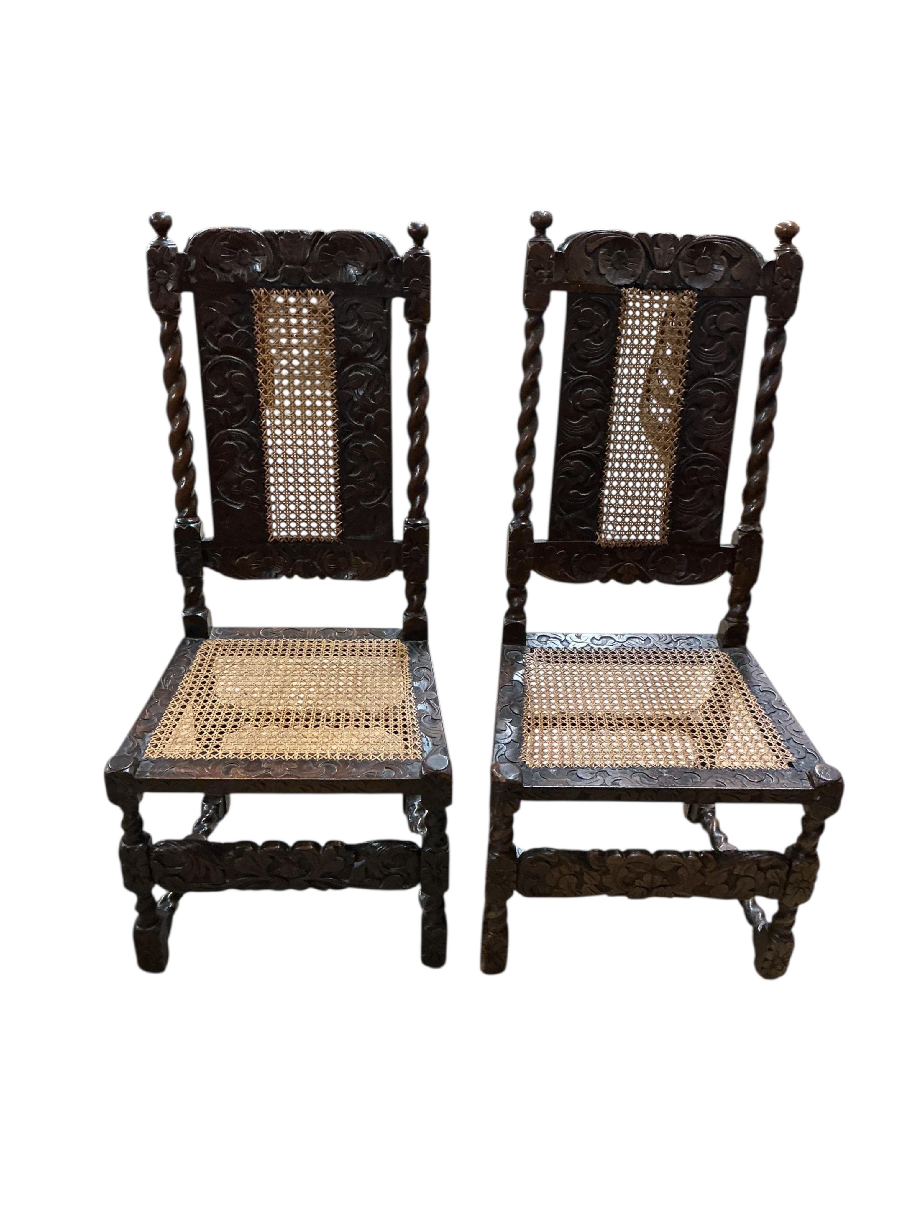 A set of four early 18th century caned walnut dining chairs, two with arms